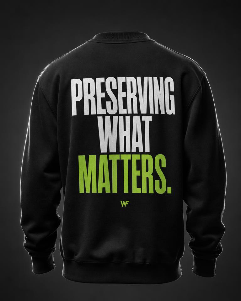 Back of a black crewneck printed with the statement Preserving What Matters